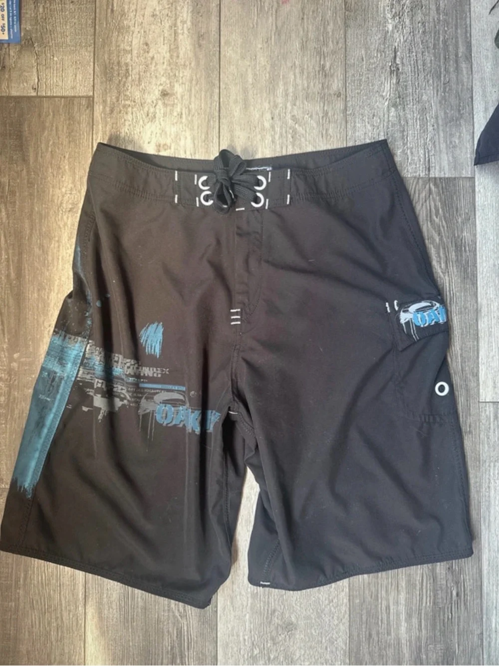 06 vintage Oakley Black Board Shorts with Blue Graphic Accents